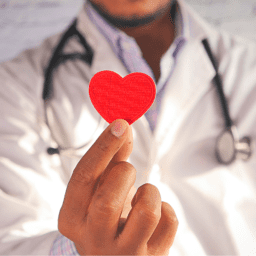 Doctor holding heart sticker