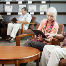 Senior man and his wife reading news on digital tablet