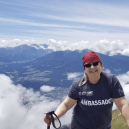 moments of victory carol clupny. Carol is atop a mountain in her Davis Phinney Foundation Ambassador shirt.