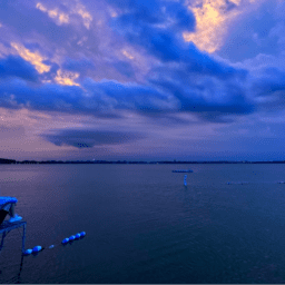 A photo of a Connie Carpenter Phinney watching a sunset over a lkae. Kathleen Crest