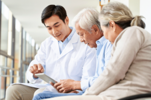 Doctor in hospital hallway explaining test results to a couple