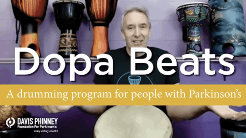 Doug Pickard sits in front of a purple wall covered in bongo drums. He is a white man with short, grey hair. Super-imposed on him is the word "DopaBeats" in white. Below that is a yellow bar wtih the words "a drumming program for people with Parkinson's". The Davis Phinney Foundation logo is in the bottom left corner.