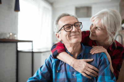 elderly woman and man hugging